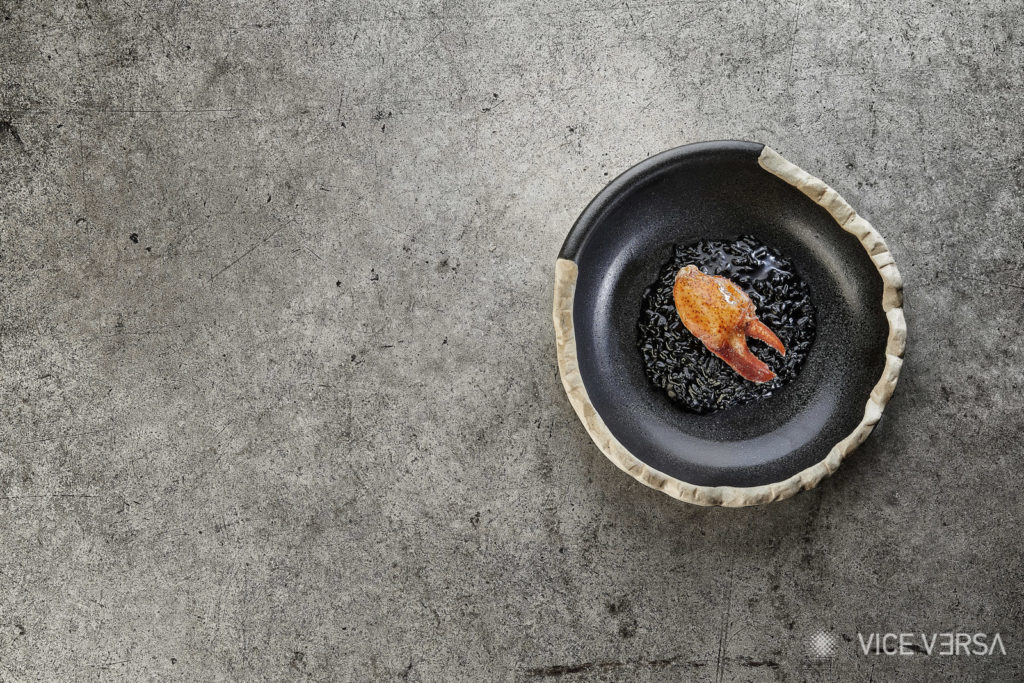 creative plate with color contrast and styling of black rice and lobster