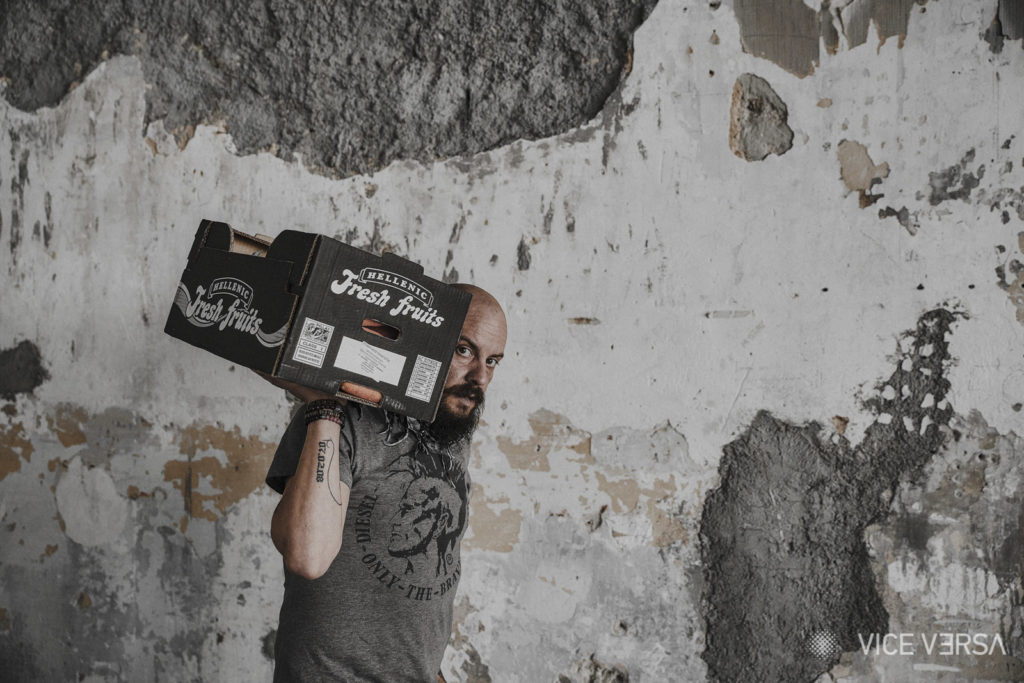 Yannis Maniksi carrying a fruit case in candid moment