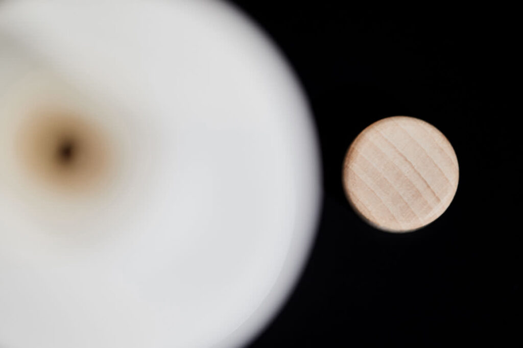 Minimal top-view composition with Mani Gaea olive oil bottle and cup