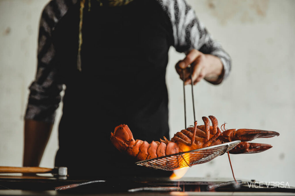 Lobster sizzling over a gas stove during culinary production