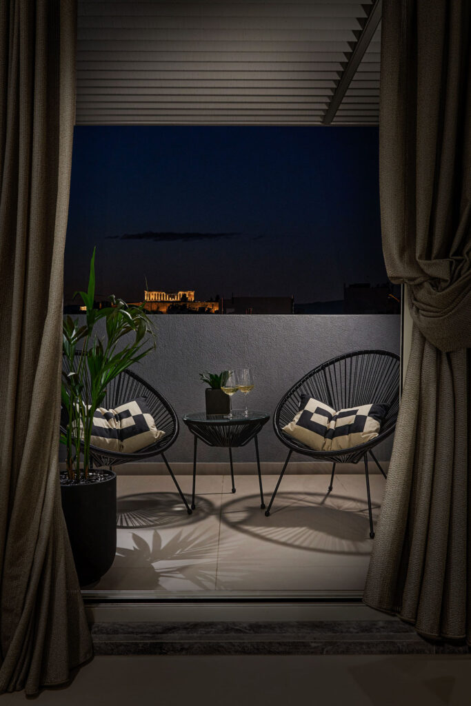 Night terrace view with illuminated Acropolis at Acacia Residences