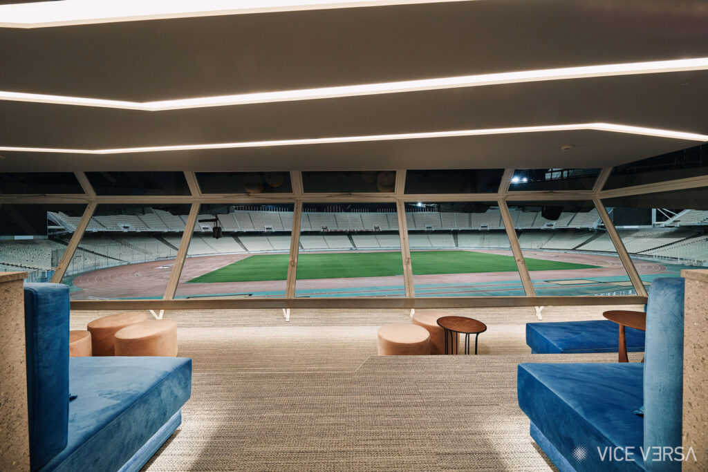 Evening interior of the OAKA Presidential Suite overlooking the playing field