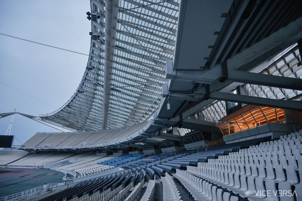 OAKA stadium stands beneath the roof structure, with the illuminated Presidential Suite above