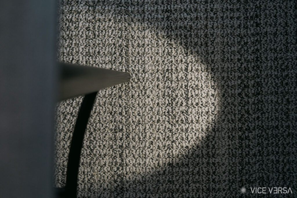 Interior architectural detail with light and shadow across a textured surface in the OAKA Presidential Suite