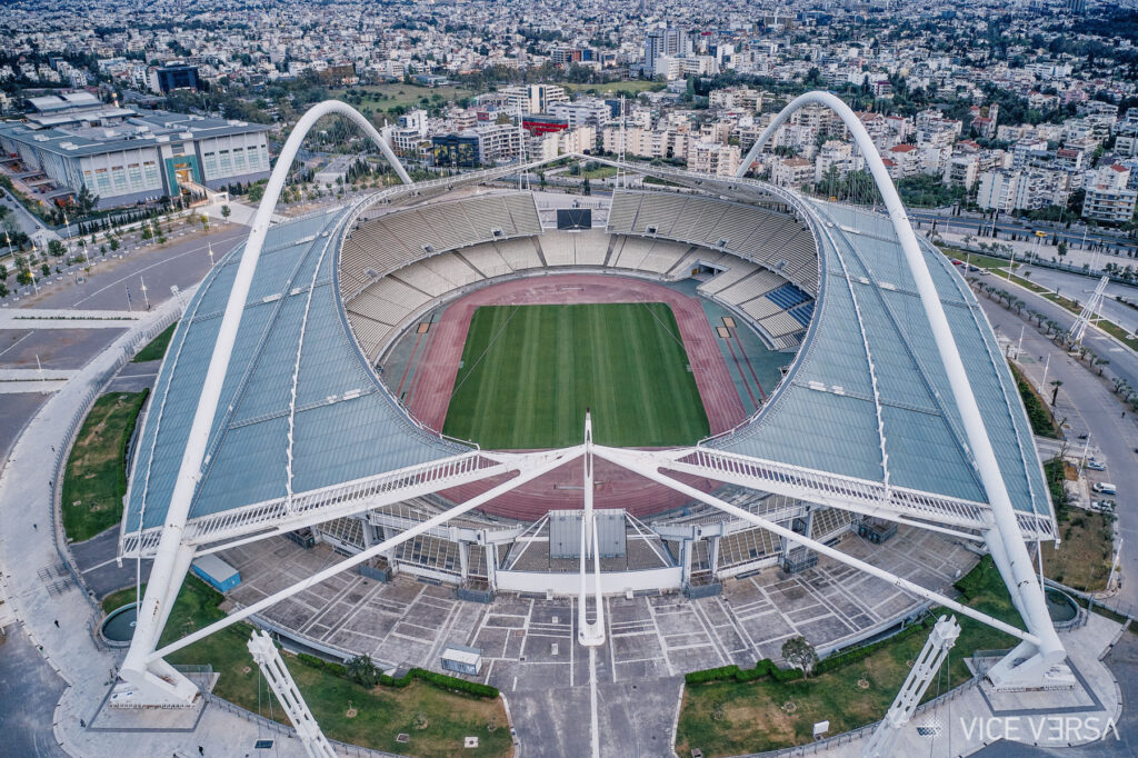 OAKA architectural project — aerial view of Athens Olympic Stadium and its sweeping roof structure