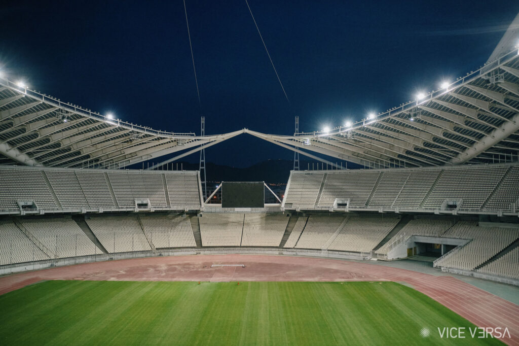 Night view of Athens Olympic Stadium’s illuminated roof and playing field — OAKA architectural project