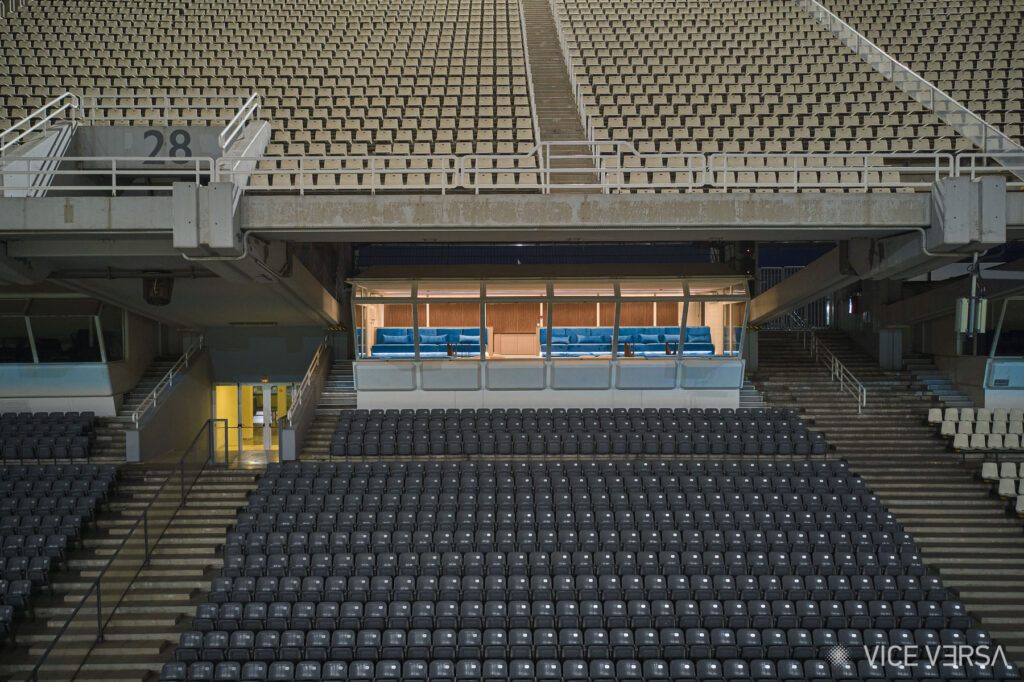 Exterior view of the illuminated OAKA Presidential Suite framed by stadium seating