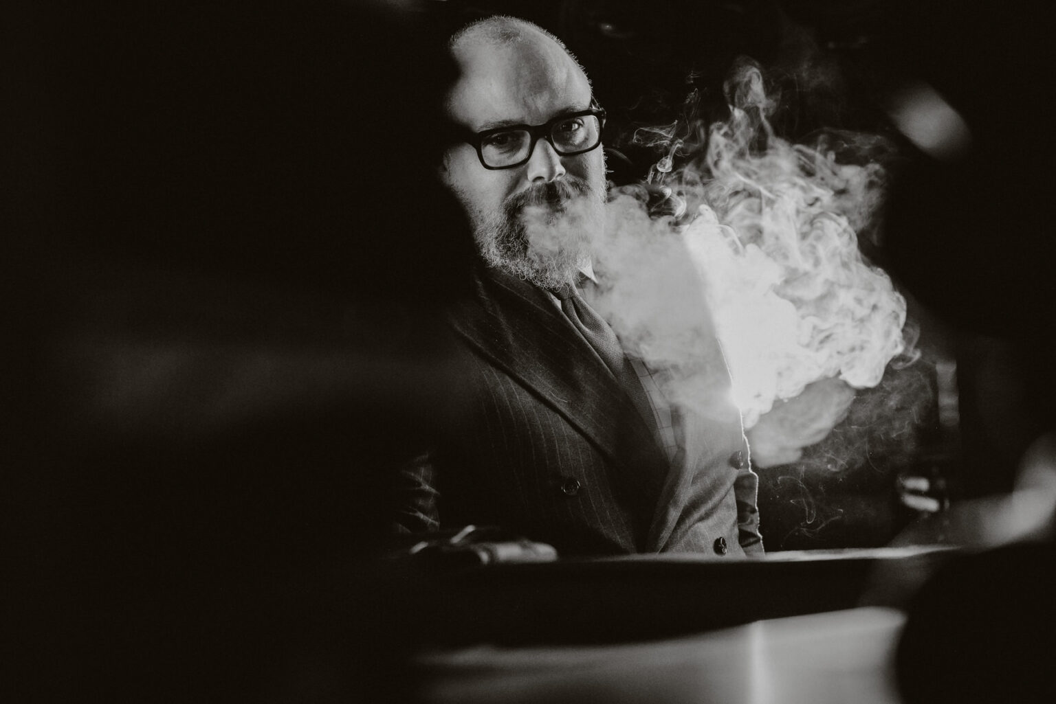 Black-and-white portrait of George Athanassopoulos surrounded by smoke in the Monopeto narrative brand film