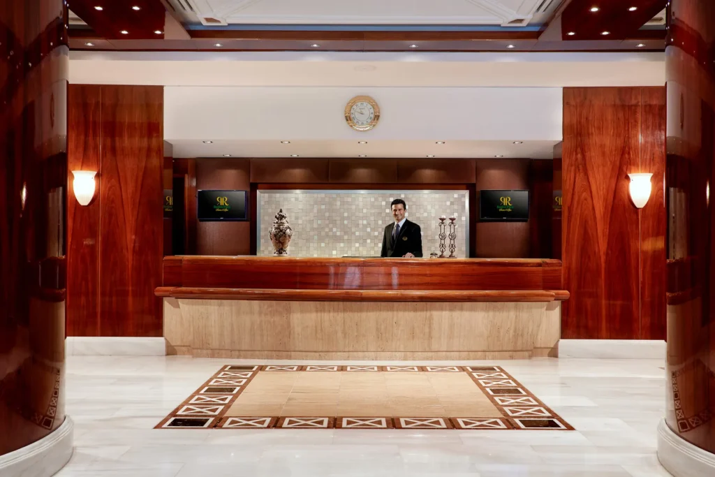 Rodos Park Hotel reception with a staff member welcoming guests
