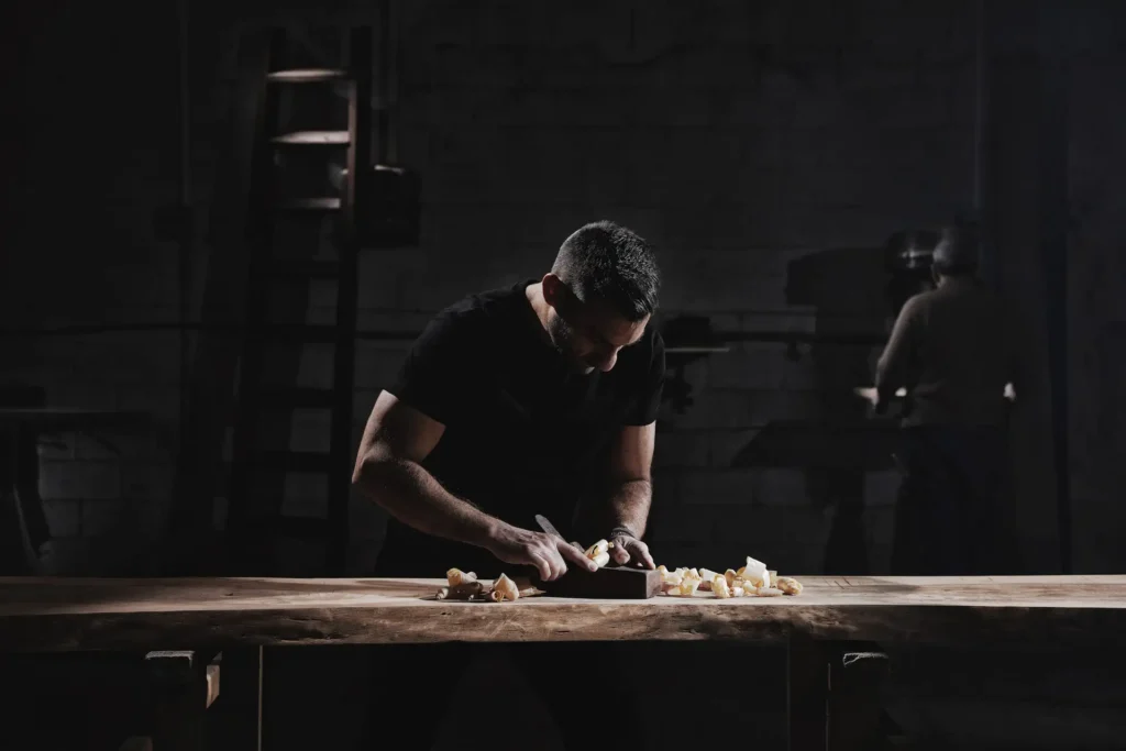 Carpenter working with specialist tools at an Anama Deco workshop bench