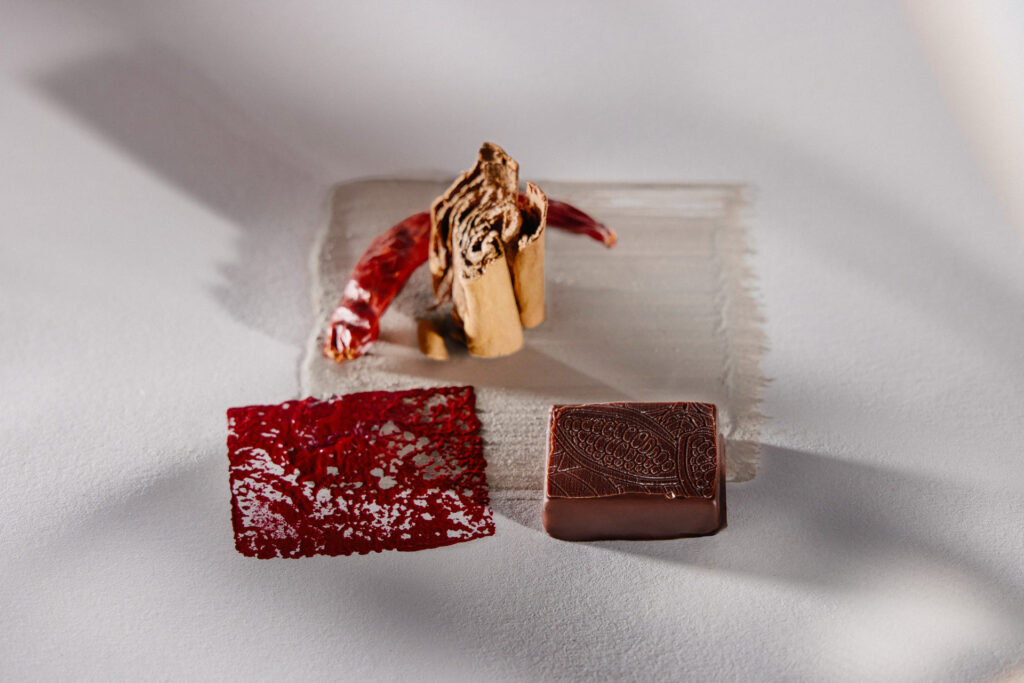 Artisanal PRALINZ bonbon on custom brand background