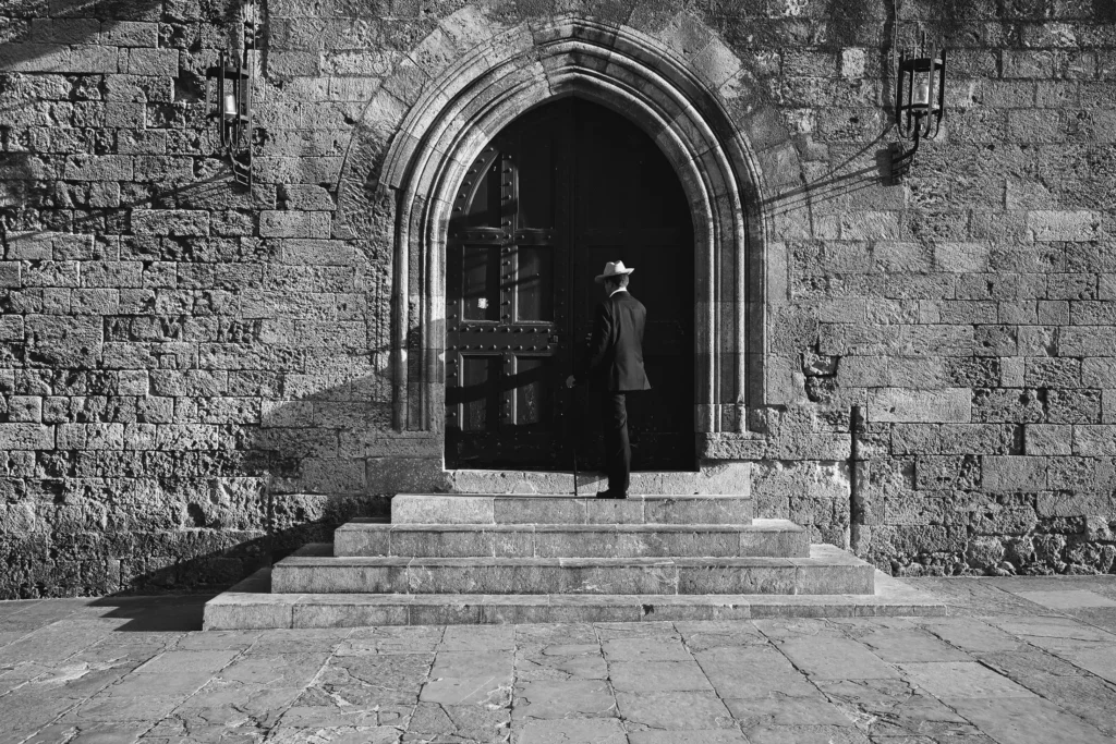 Lifestyle portrait in front of a medieval wooden door in Rhodes Old Town