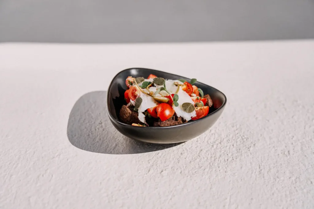 Fresh salad plating at Charisma restaurant in Oia