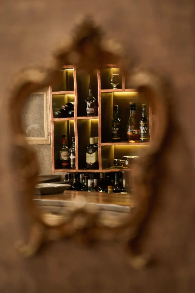 Cafe bar viewed through mirror reflection in renovated interior