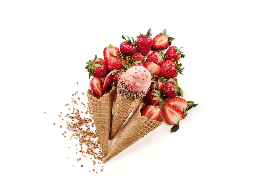 Creative ice cream composition with cones and strawberries for Callebaut