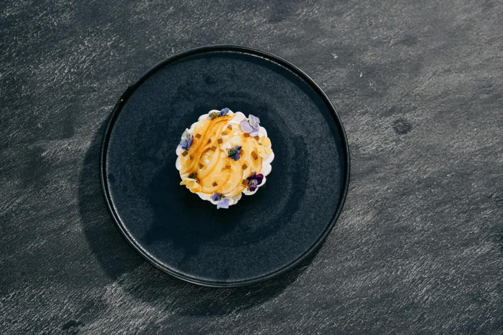 Top-view fine-dining dessert on textured stone background