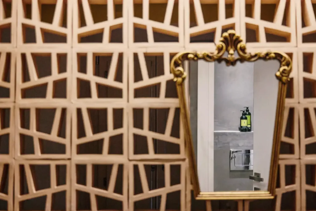 Interior mirror detail reflecting the shower area at The Monk Leros
