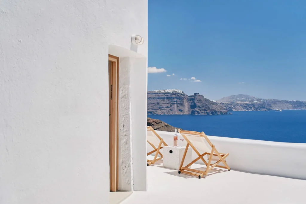The Mill Haven windmill in Oia overlooking Imerovigli and Skaros Rock