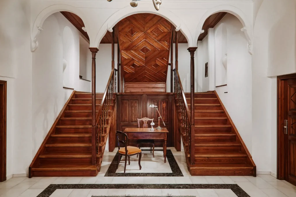 Historic mansion entrance at Despotiko with vintage desk and staircase