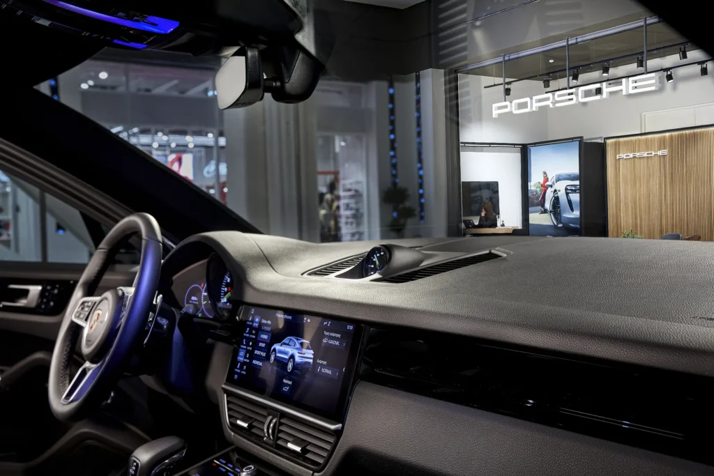 Porsche steering wheel and dashboard under controlled lighting