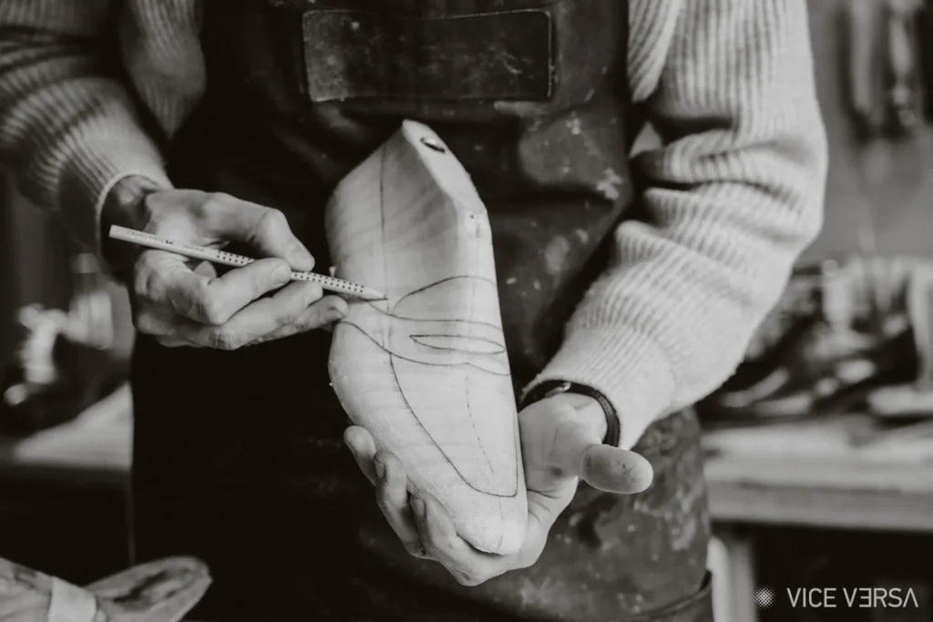Joras sketching details on wooden shoe last