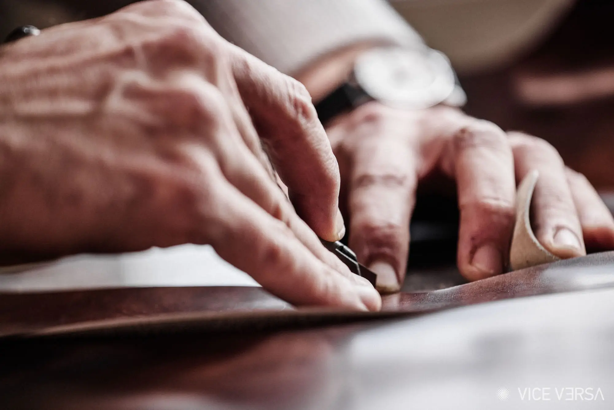 bespoke shoemaker marking leather with pencil