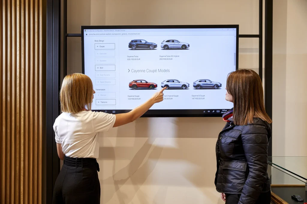 Porsche representative presenting the vehicle to a customer