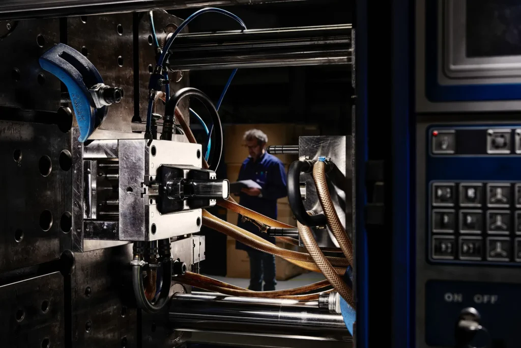 Industrial machine operating with employee in the background at Bazigos