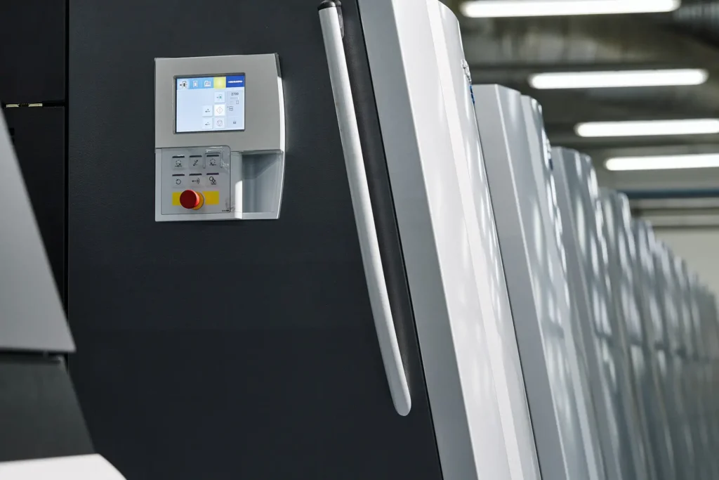 Corporate Photography for factories showing a printing press control panel and a row of press units