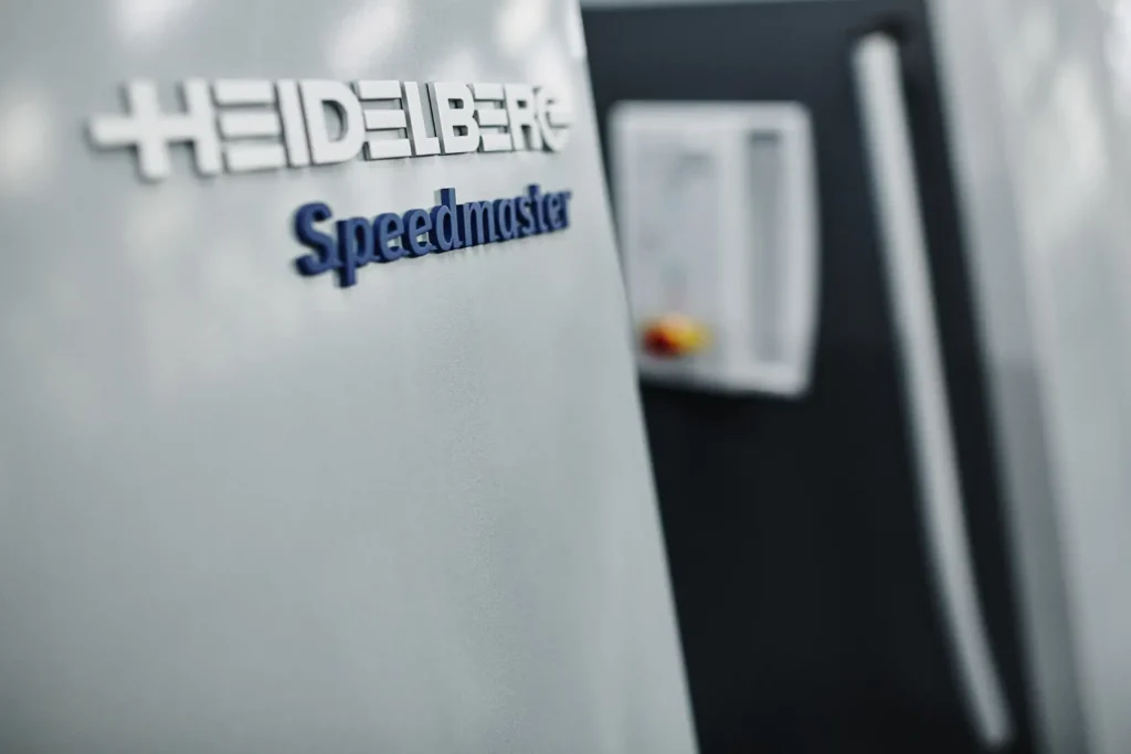 Close-up of the Heidelberg Speedmaster badge on a printing press