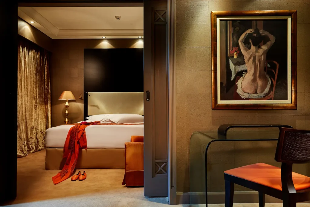 Rodos Park guest room with bed and glass work desk