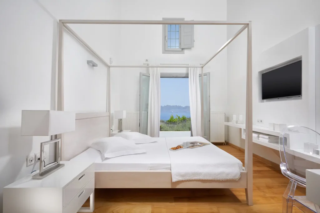 Whitewashed guest room at Akrotiri Private Residence with sea view