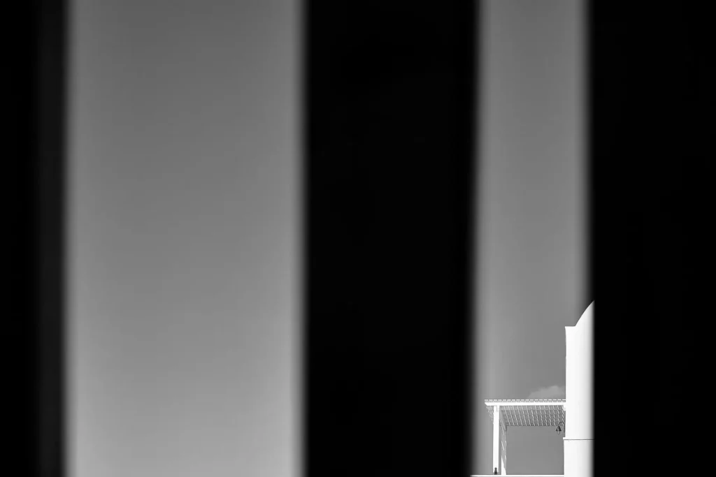 Minimal black-and-white exterior of Petri Suites in Santorini
