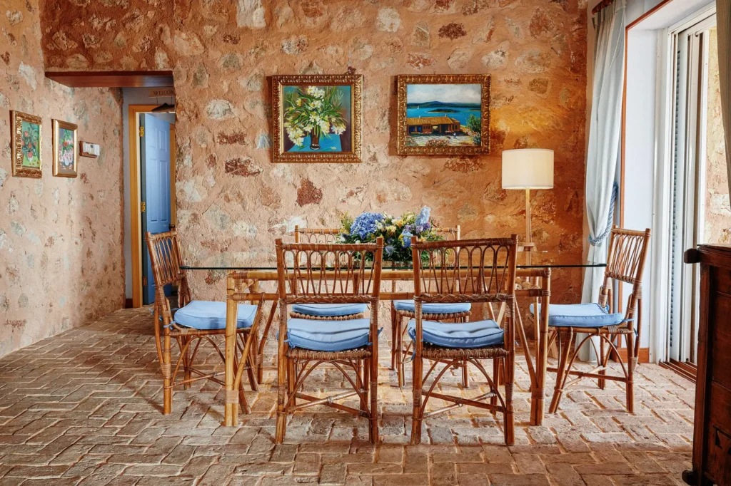 Villa Halioussa lounge with bamboo furniture and stone walls