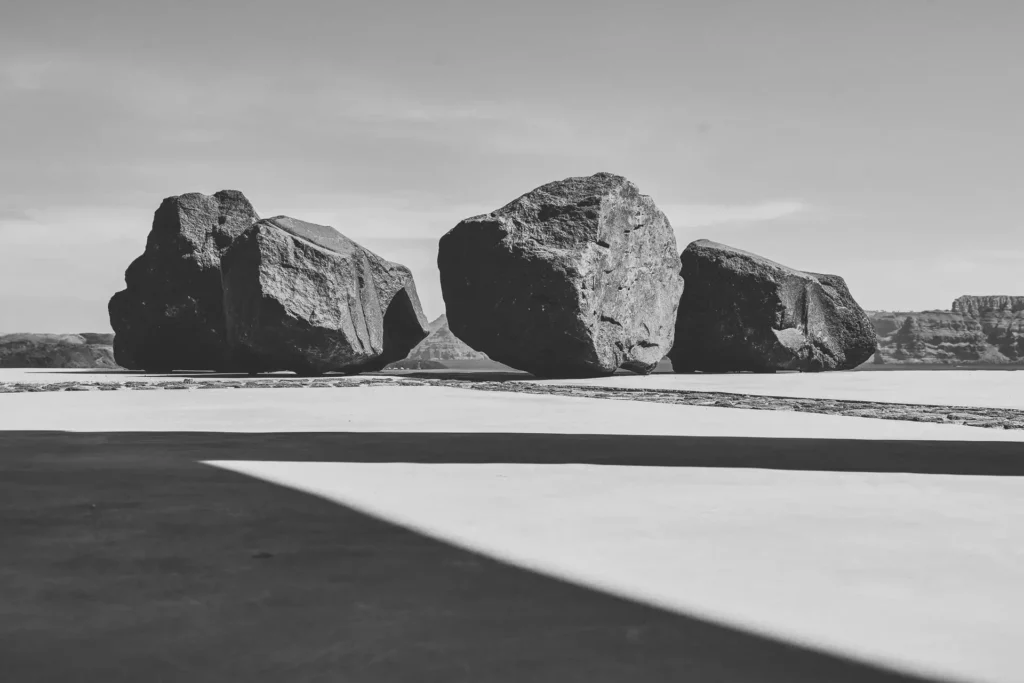 Black-and-white view of volcanic rock details beside the pool at Akrotiri Private Residence