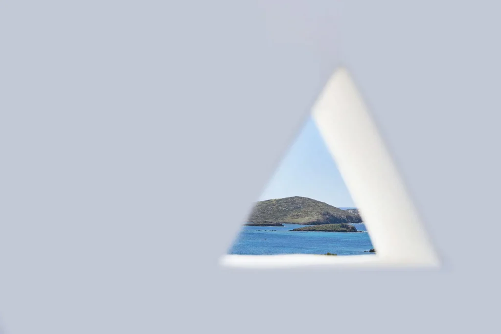 Minimal sea view through triangular opening at Agnadi Studios in Astypalaia