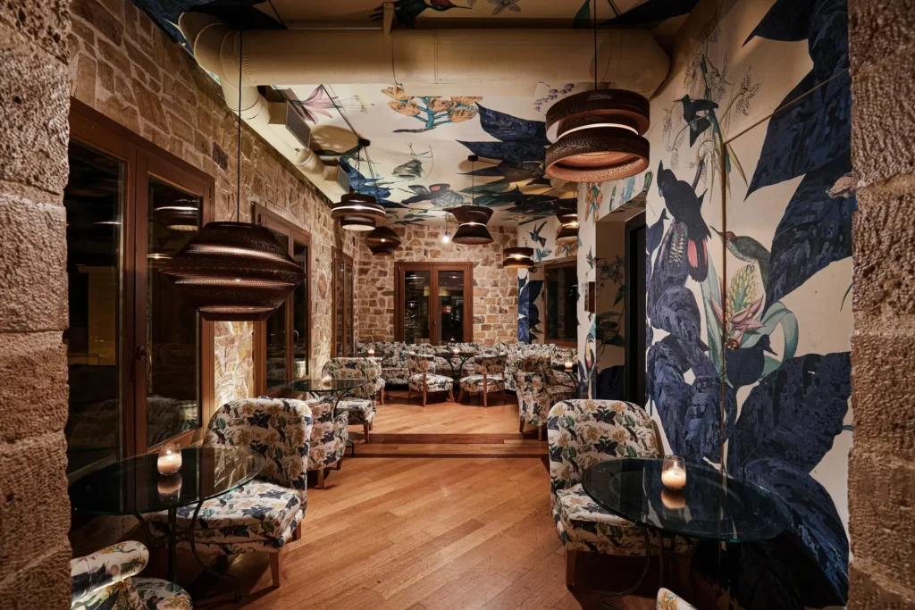 Upper-floor seating area with bird-pattern wallpaper at Zambri