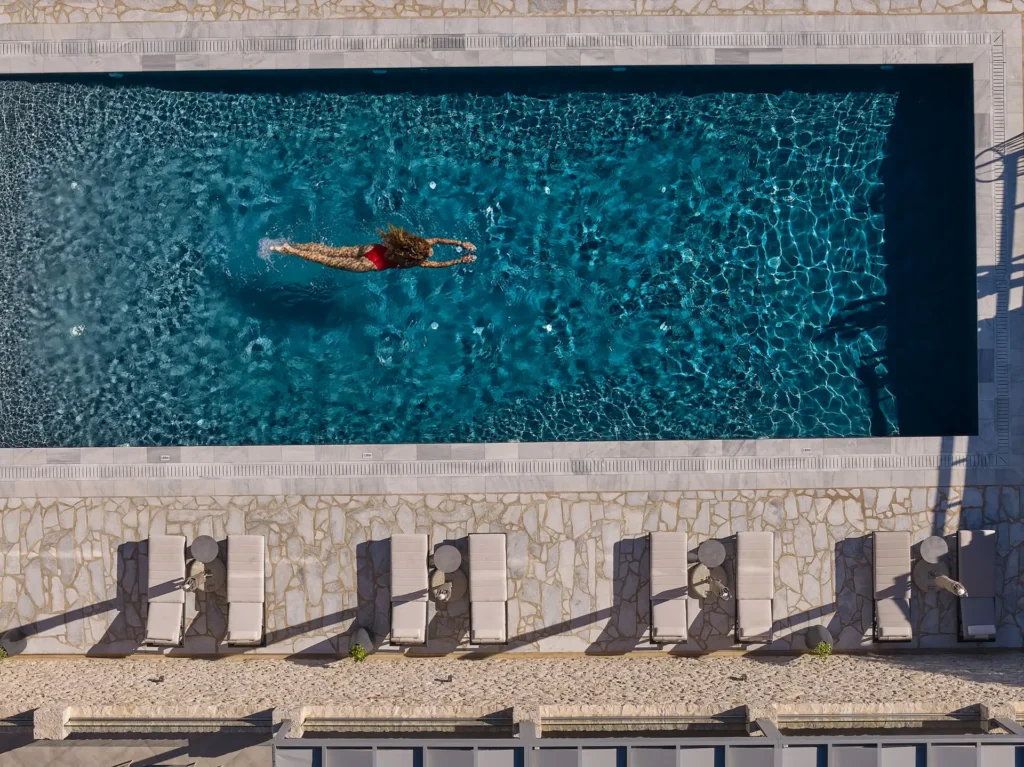 Aerial view of Quattro Suites pool with guest diving