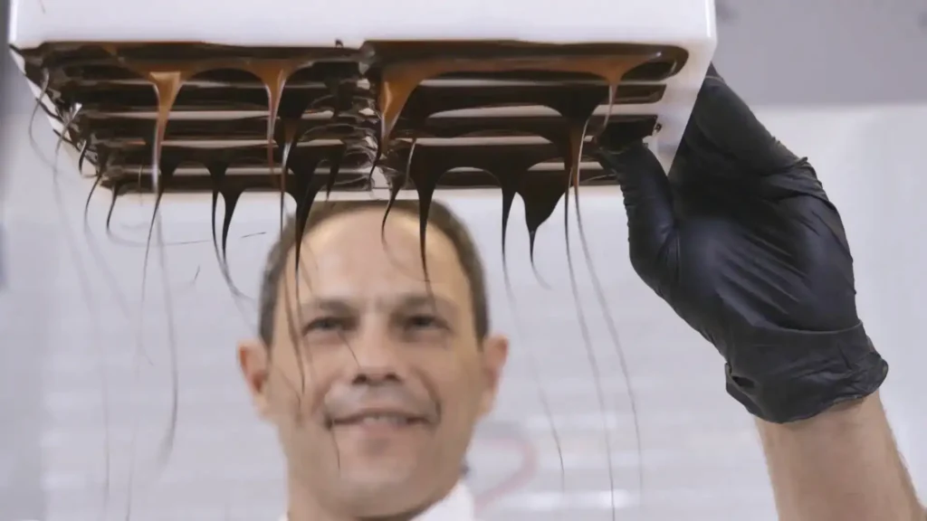 Nektarios Vourikis preparing bonbons with characteristic flowing chocolate