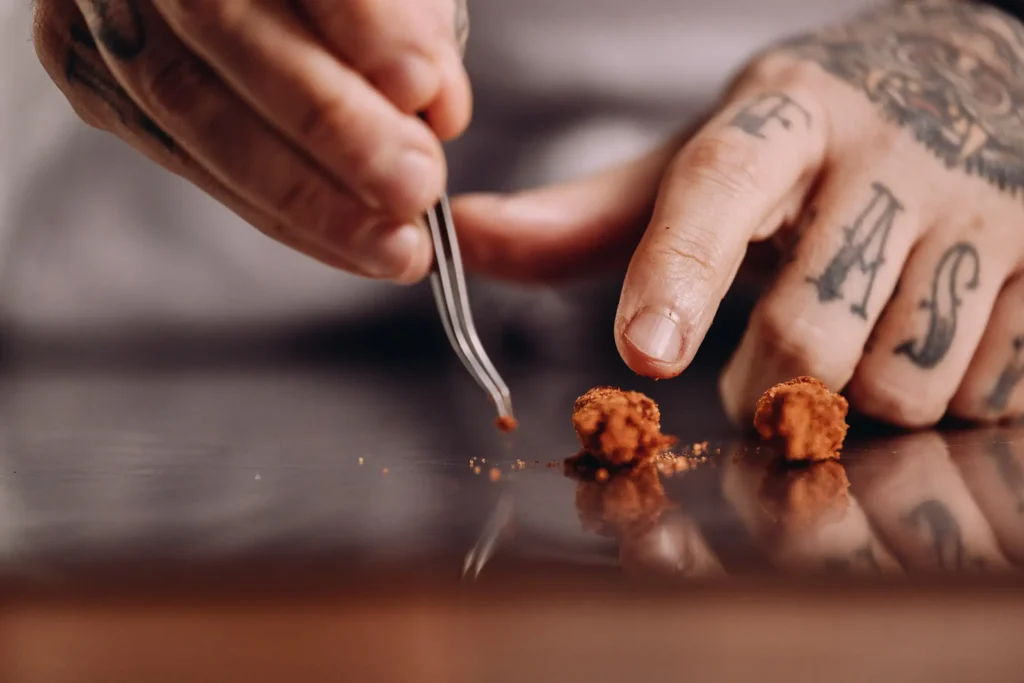 close up chef hands with tatoos