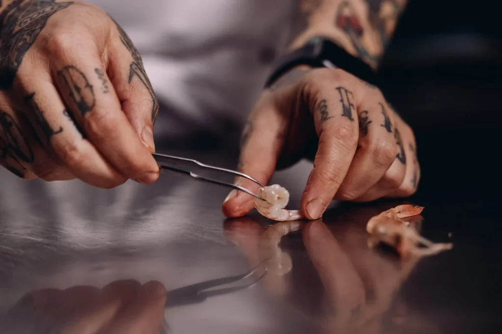 chef hands close up positioning shrimp